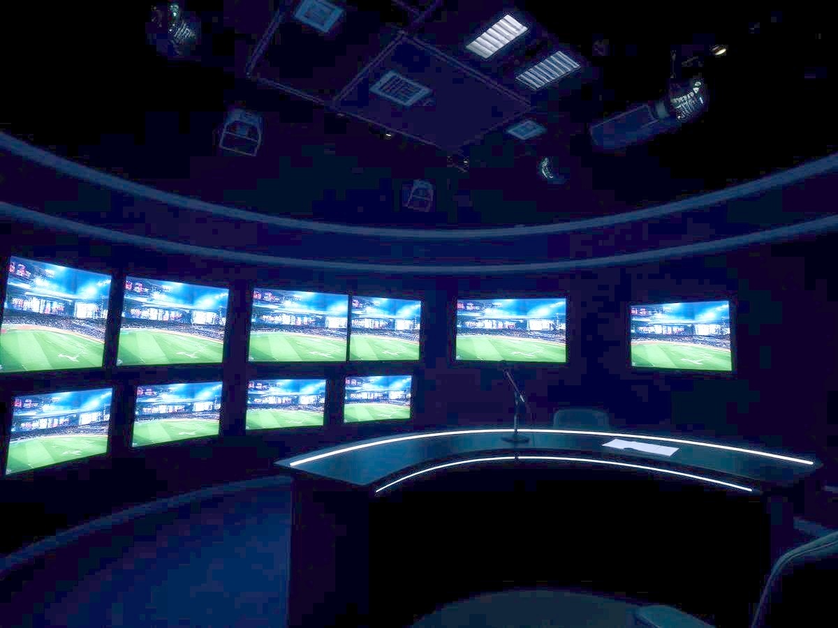 Television sports studio with a bank of glowing monitors